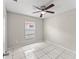 Cozy bedroom with tile floors, a ceiling fan, and a bright window, offering comfortable living at 2317 Santa Lucia St, Kissimmee, FL 34743