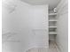 Spacious walk-in closet with multiple shelves, providing ample storage and organization options at 2317 Santa Lucia St, Kissimmee, FL 34743