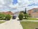 Front view of a house with a driveway and green lawn at 2317 Santa Lucia St, Kissimmee, FL 34743
