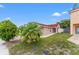 A charming single-story house with a well-maintained lawn and a beautiful palm tree in the front yard at 2317 Santa Lucia St, Kissimmee, FL 34743