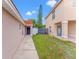 Charming home exterior featuring a blue front door and manicured lawn leading to the house at 2317 Santa Lucia St, Kissimmee, FL 34743