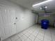 Attached garage with tiled floor, door to house, and overhead door at 2317 Santa Lucia St, Kissimmee, FL 34743