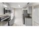 Modern kitchen with stainless steel appliances, granite countertops, and sleek gray cabinetry at 2317 Santa Lucia St, Kissimmee, FL 34743