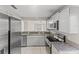 Well-equipped kitchen boasting stainless steel appliances, granite countertops, and bright white cabinets at 2317 Santa Lucia St, Kissimmee, FL 34743