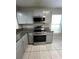 Modern kitchen with stainless steel appliances and gray cabinets at 2317 Santa Lucia St, Kissimmee, FL 34743