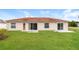 Home with grassy backyard and patio at 2543 Sage Dr, Kissimmee, FL 34758