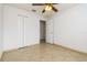 Bedroom with tile floors, double door closet and ceiling fan at 2543 Sage Dr, Kissimmee, FL 34758