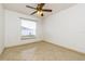 Bedroom with tile floors, window, and ceiling fan at 2543 Sage Dr, Kissimmee, FL 34758