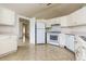 Efficient kitchen with white cabinets, appliances, and tile floor at 2543 Sage Dr, Kissimmee, FL 34758