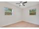 Bright bedroom with light wood floors and two windows at 2913 W Amelia St, Orlando, FL 32805