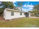 White single story home with a landscaped yard and gray accents at 2913 W Amelia St, Orlando, FL 32805