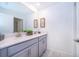 Bright, modern bathroom featuring double sinks and a large mirror at 2974 Protagonist St, Kissimmee, FL 34746