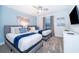 Comfortable bedroom with two beds, soft blue accents, and natural light from the window at 2974 Protagonist St, Kissimmee, FL 34746