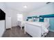 Bedroom with two twin beds and teal colored accent wall at 2974 Protagonist St, Kissimmee, FL 34746