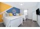 Bedroom with two twin beds and a blue and yellow accent wall at 2974 Protagonist St, Kissimmee, FL 34746