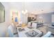 Open-concept dining area connected to kitchen, featuring a stylish table setting and modern pendant lighting at 2974 Protagonist St, Kissimmee, FL 34746