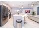 Modern kitchen with stainless steel appliances, a center island with bar seating, and stylish pendant lights at 2974 Protagonist St, Kissimmee, FL 34746