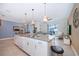Open concept kitchen with island and view of living room and pool at 2974 Protagonist St, Kissimmee, FL 34746