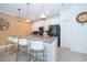 White kitchen cabinets, granite countertop, and stylish pendant lighting at 2974 Protagonist St, Kissimmee, FL 34746
