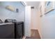 Laundry room with washer, dryer, and shelving at 2974 Protagonist St, Kissimmee, FL 34746