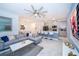 Bright open-concept living space featuring modern furnishings, including a sectional sofa and a stylish kitchen area at 2974 Protagonist St, Kissimmee, FL 34746