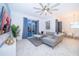 Spacious living area with a modern sectional sofa, entertainment center, and large sliding doors to outdoor space at 2974 Protagonist St, Kissimmee, FL 34746