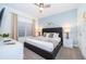 Stylized main bedroom featuring ceiling fan, large windows, and carpet at 2974 Protagonist St, Kissimmee, FL 34746