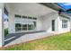 Covered patio with sliding glass doors and access to backyard at 3032 Kensington Ave, Davenport, FL 33837