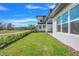 Landscaped backyard with lush green grass and golf course view at 3032 Kensington Ave, Davenport, FL 33837