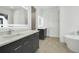 Modern bathroom with a free-standing tub and double vanity at 3032 Kensington Ave, Davenport, FL 33837