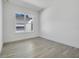 Simple bedroom with large window and hardwood floors at 3032 Kensington Ave, Davenport, FL 33837