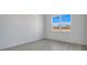 Well-lit bedroom with large window and wood-look floors at 3032 Kensington Ave, Davenport, FL 33837