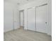 Modern bedroom with double closets and wood-look floors at 3032 Kensington Ave, Davenport, FL 33837