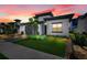 Modern house exterior with gray garage door at dusk at 3032 Kensington Ave, Davenport, FL 33837