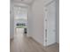 Bright hallway with light wood floors leading to the kitchen at 3032 Kensington Ave, Davenport, FL 33837