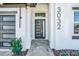 Modern house entrance with gray door and paver walkway at 3032 Kensington Ave, Davenport, FL 33837