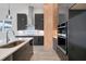 Modern kitchen with dark cabinetry, stainless steel appliances, and white countertop at 3032 Kensington Ave, Davenport, FL 33837