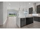 Modern kitchen with dark cabinetry, island, and stainless steel appliances at 3032 Kensington Ave, Davenport, FL 33837