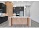 Modern kitchen island with wood slat detailing and white countertop at 3032 Kensington Ave, Davenport, FL 33837