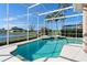 Inviting pool area with spa and screened enclosure, offering lake views at 3736 Brookmyra Dr, Orlando, FL 32837