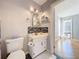 Bright bathroom with vanity, toilet, and view of another room at 421 Sheoah Blvd # 5, Winter Springs, FL 32708