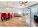 Bright dining area with red chairs and a round table, hardwood floors, and access to a patio at 421 Sheoah Blvd # 5, Winter Springs, FL 32708