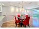 Dining area features a round table with red chairs and hardwood floors at 421 Sheoah Blvd # 5, Winter Springs, FL 32708