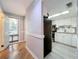 White kitchen with granite counters, black appliances, and tile floors at 421 Sheoah Blvd # 5, Winter Springs, FL 32708