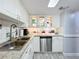 Updated kitchen with white cabinets, granite counters, and stainless steel appliances at 421 Sheoah Blvd # 5, Winter Springs, FL 32708