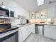 Bright kitchen, granite counters, stainless steel appliances, and white cabinets at 421 Sheoah Blvd # 5, Winter Springs, FL 32708
