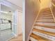 View of kitchen with stainless steel appliances and adjacent staircase with inspirational quotes at 421 Sheoah Blvd # 5, Winter Springs, FL 32708