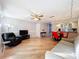 Open living area with hardwood floors, a couch and a recliner, and views into the kitchen and dining area at 421 Sheoah Blvd # 5, Winter Springs, FL 32708