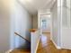 View of an upstairs hallway with light hardwood floors and access to bedroom at 421 Sheoah Blvd # 5, Winter Springs, FL 32708