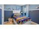 Bright bedroom with nautical-themed bedding and built-in storage at 4225 Singing Mockingbird Blvd, Bartow, FL 33830